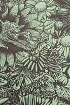 Bloom print of a hummingbird among flowers and leaves in green and olive