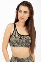 model wearing a cream black feather cross-back bra from funky simplicity shown from the front