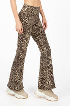 A woman wearing Funky Simplicity wild animal-print flared leggings in cream brown color shown from the front.