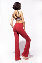 Model wearing Red Cotton Lycra Flares from Funky Simplicity worn with a cream black Nagomi printed Yoga cross back bra shown from the back