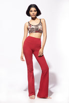 Model wearing Red Cotton Lycra Flares from Funky Simplicity worn with a cream black Nagomi printed Yoga cross back bra shown from the front