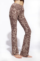 A woman wearing Funky Simplicity wild animal-print flared leggings in cream brown color shown from the front